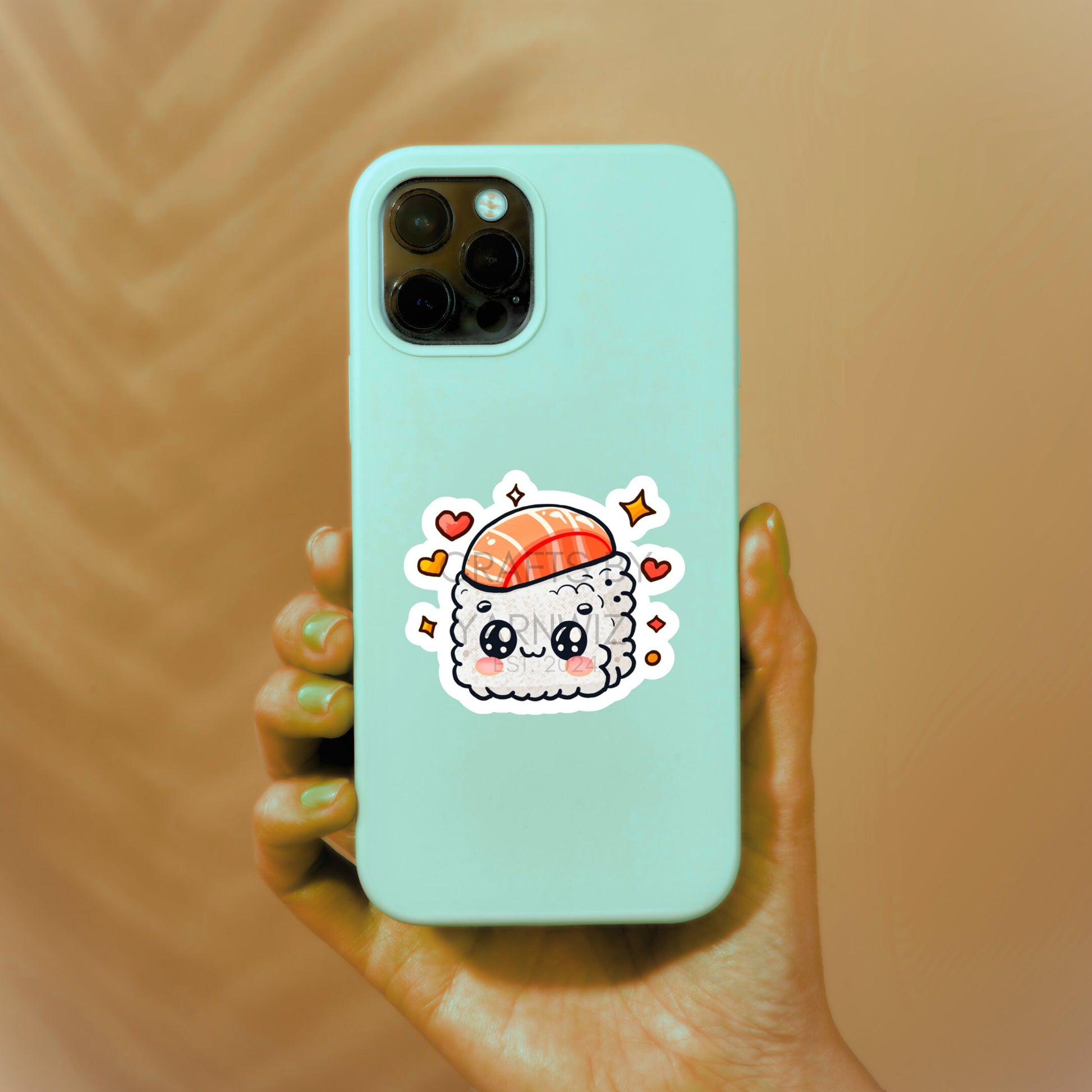 a person holding a phone case with a sushi sticker on it