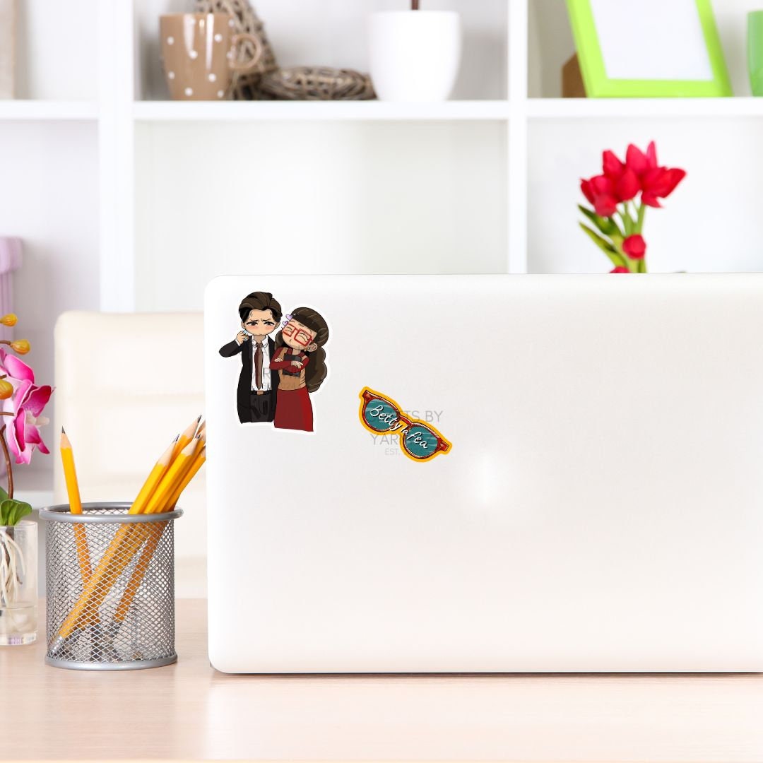 a laptop with a sticker of two people on it