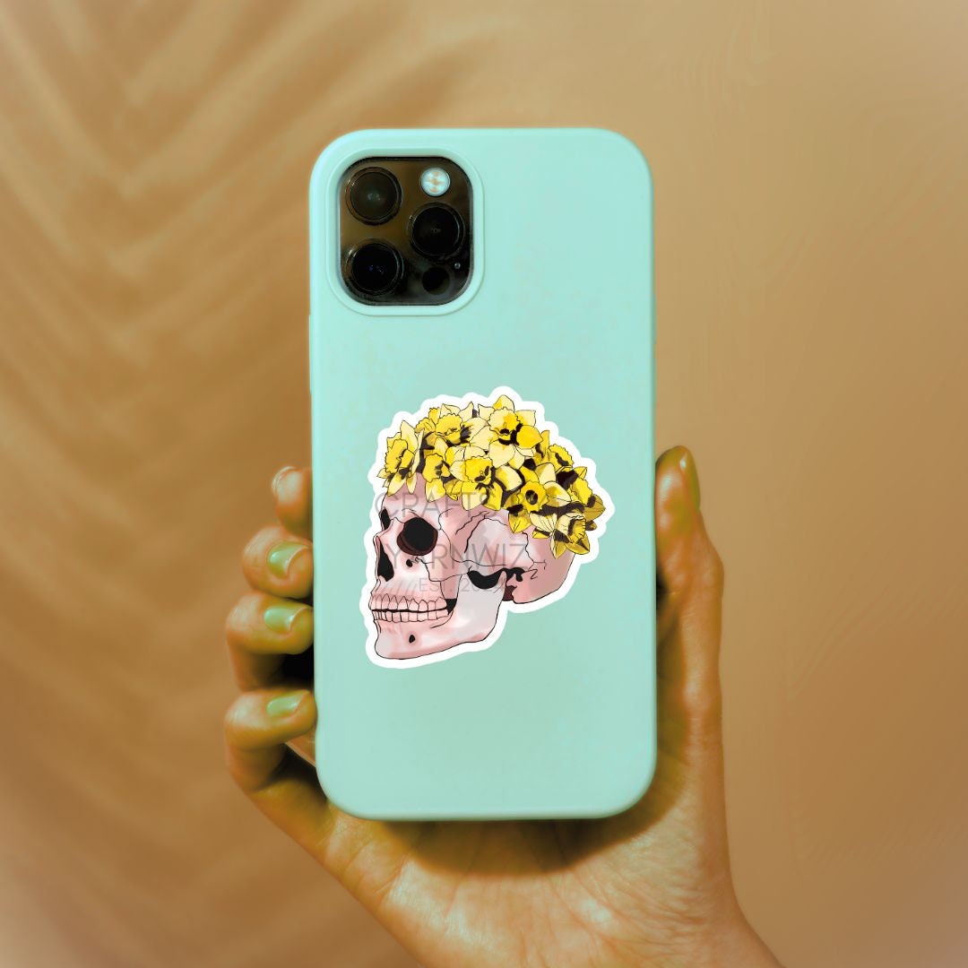 a person holding a phone with a sticker on it