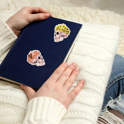 a person holding a book with stickers on it