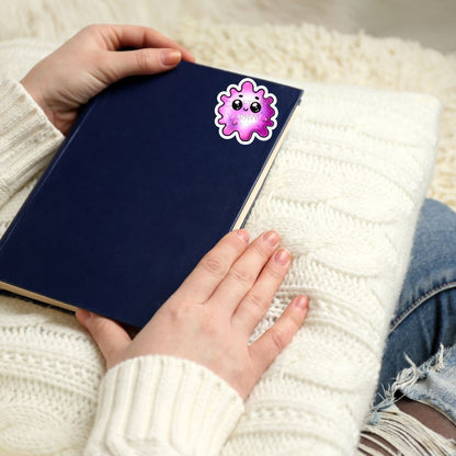 a person holding a book with a sticker on it