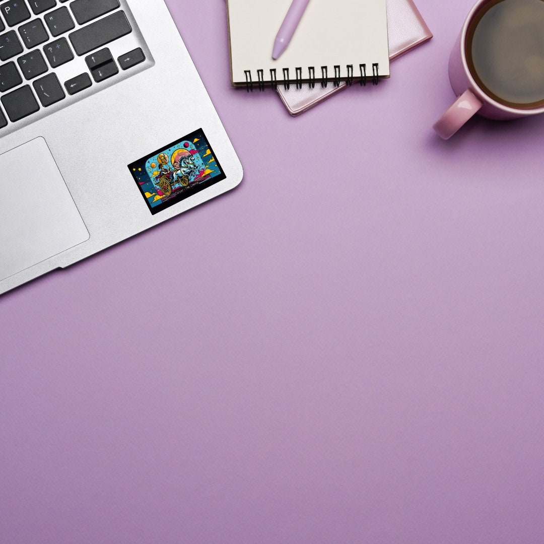 a laptop computer sitting on top of a desk next to a cup of coffee