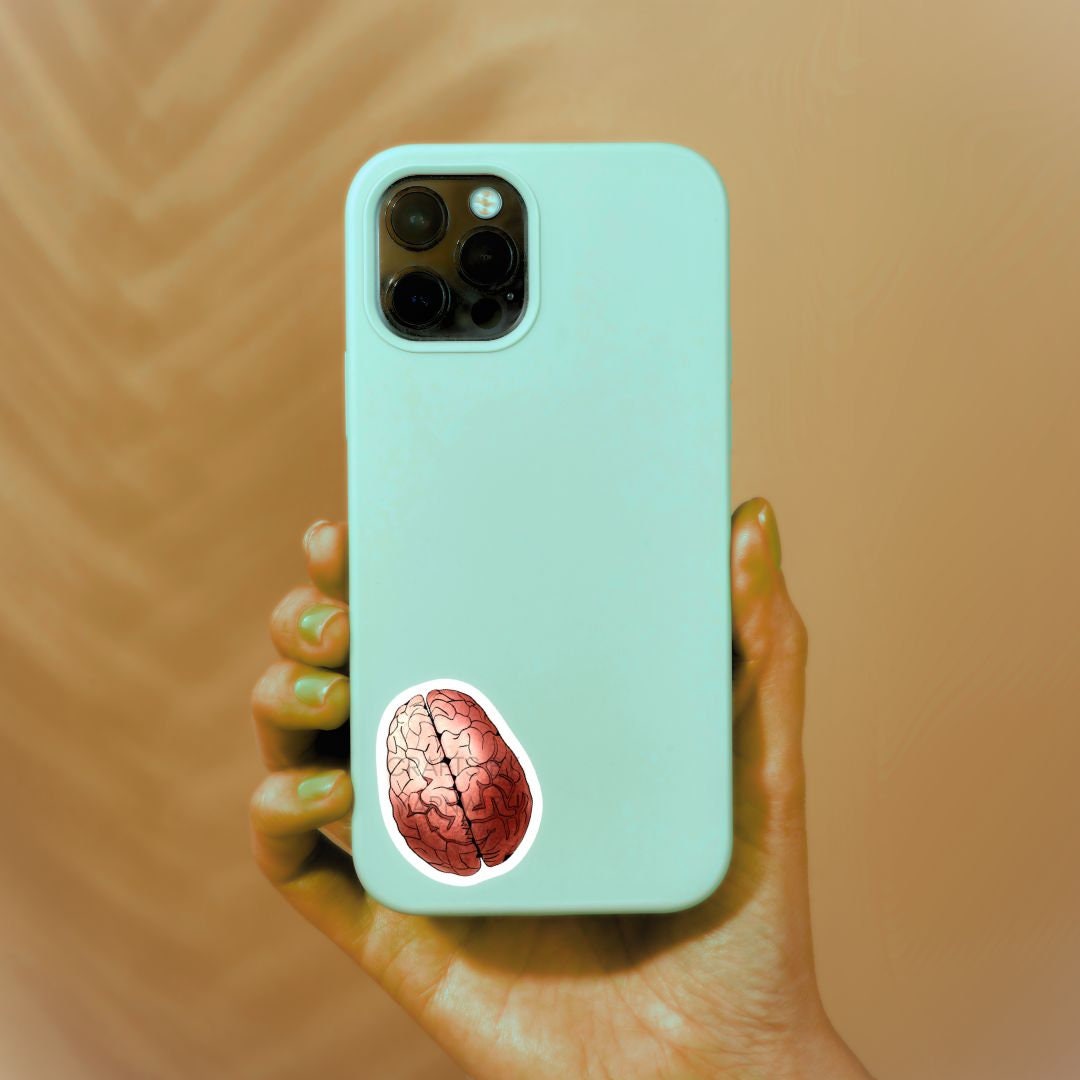 a person holding a phone with a brain sticker on it