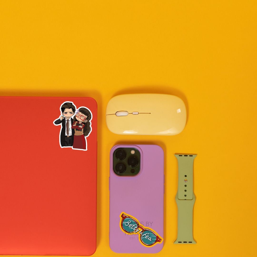 a cell phone, mouse, and sticker on a yellow surface