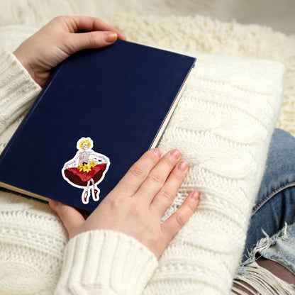 a person holding a book with a sticker on it