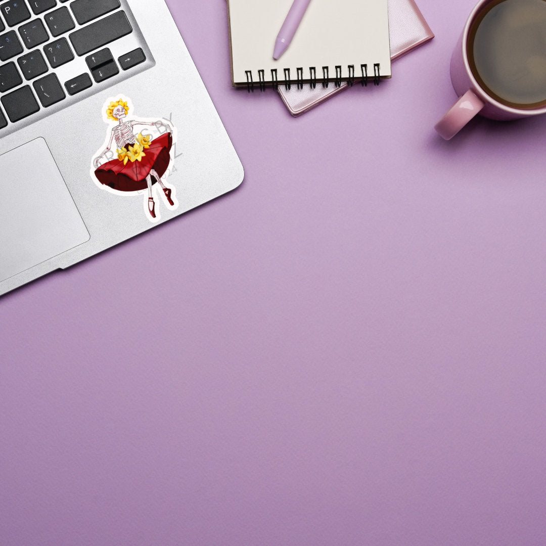 a laptop computer sitting on top of a desk next to a cup of coffee