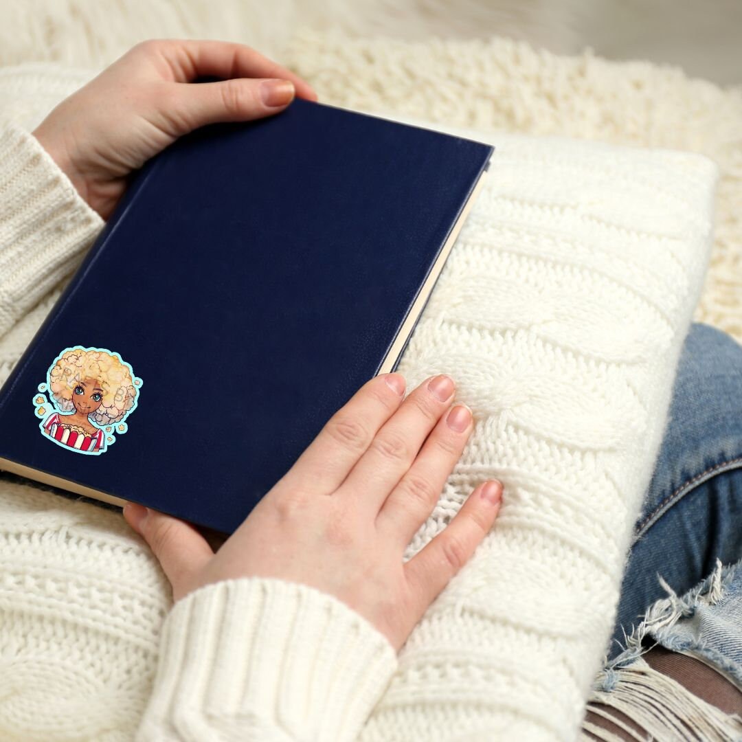 a person is holding a book with a sticker on it