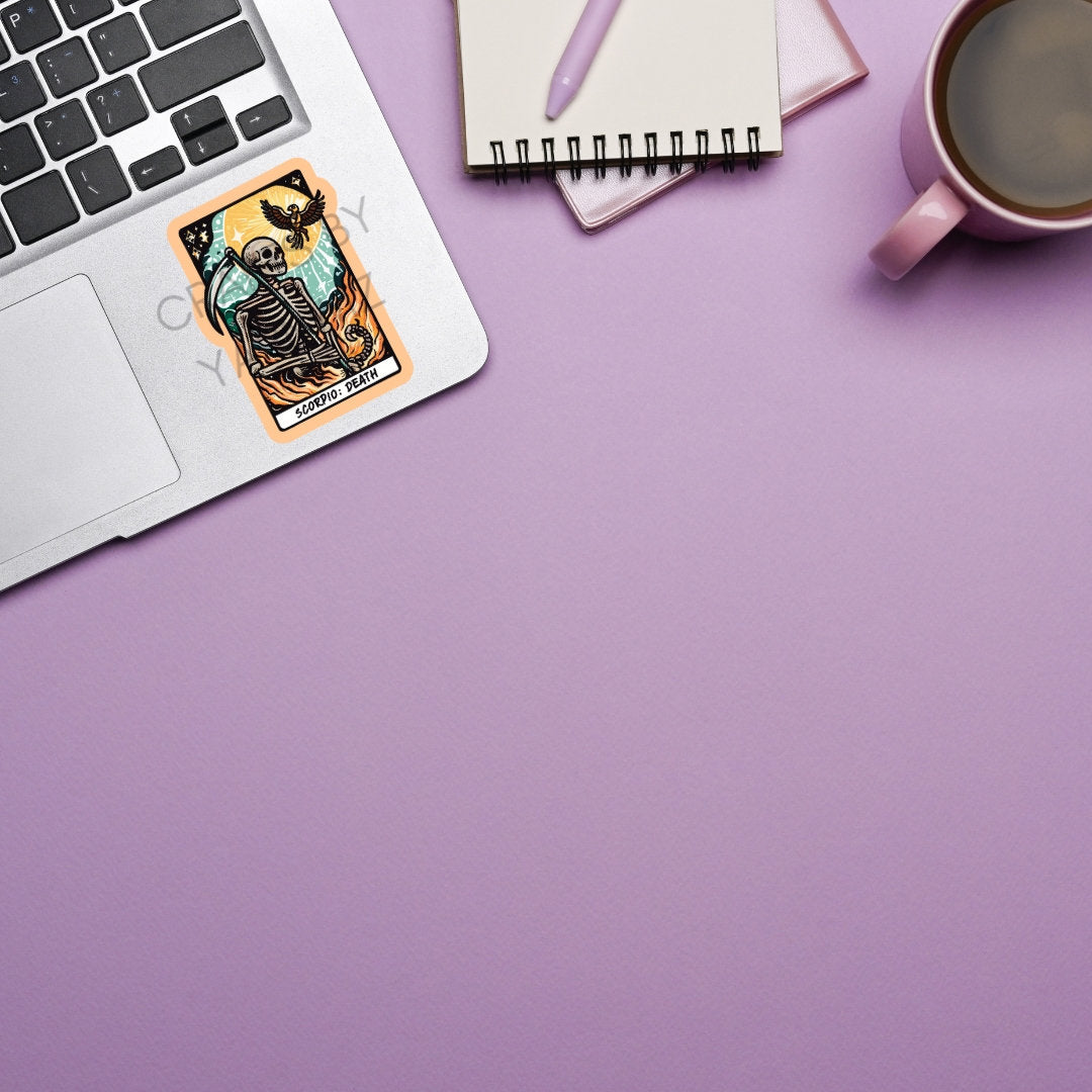 a cup of coffee next to a laptop on a purple surface