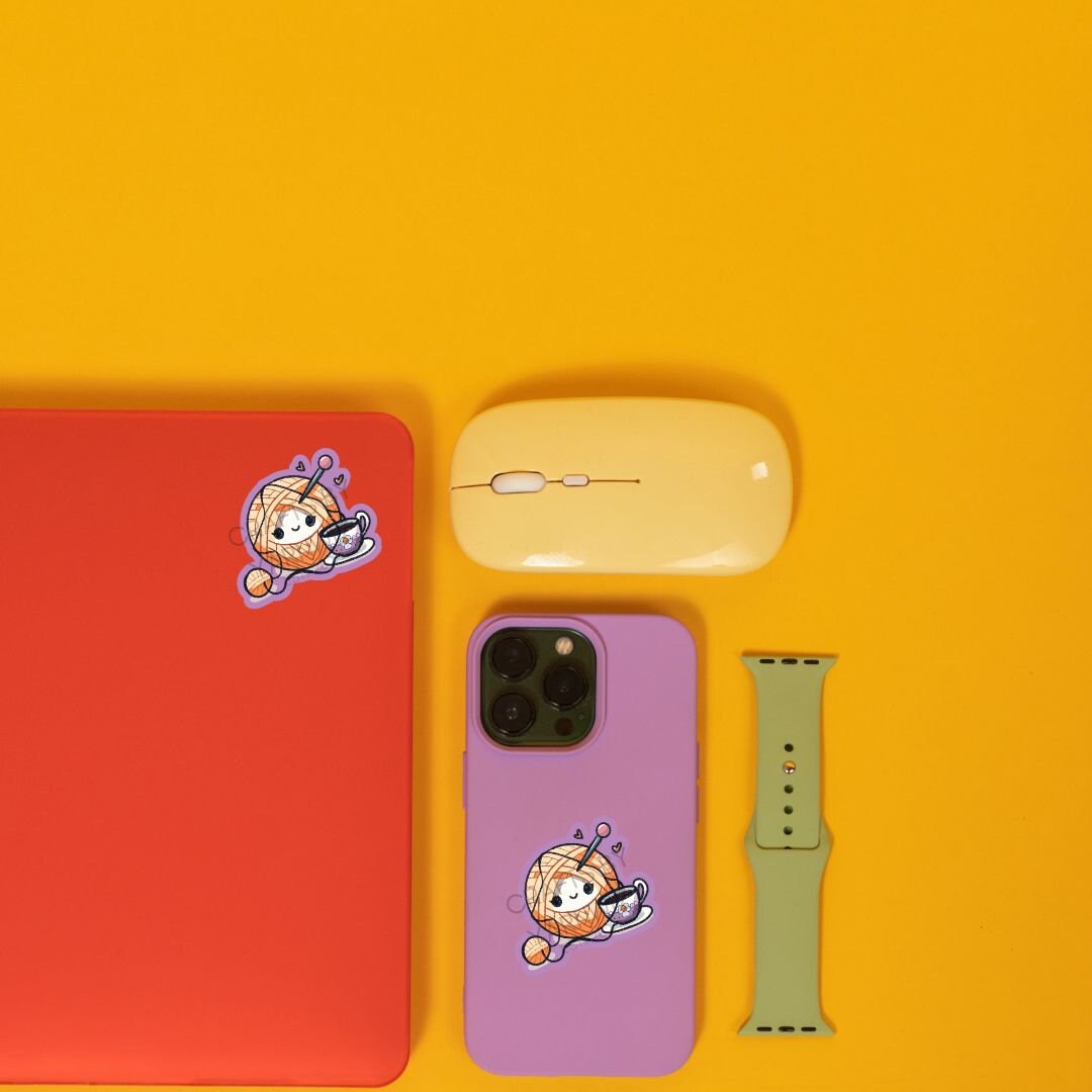 a cell phone, mouse, and other items on a yellow surface