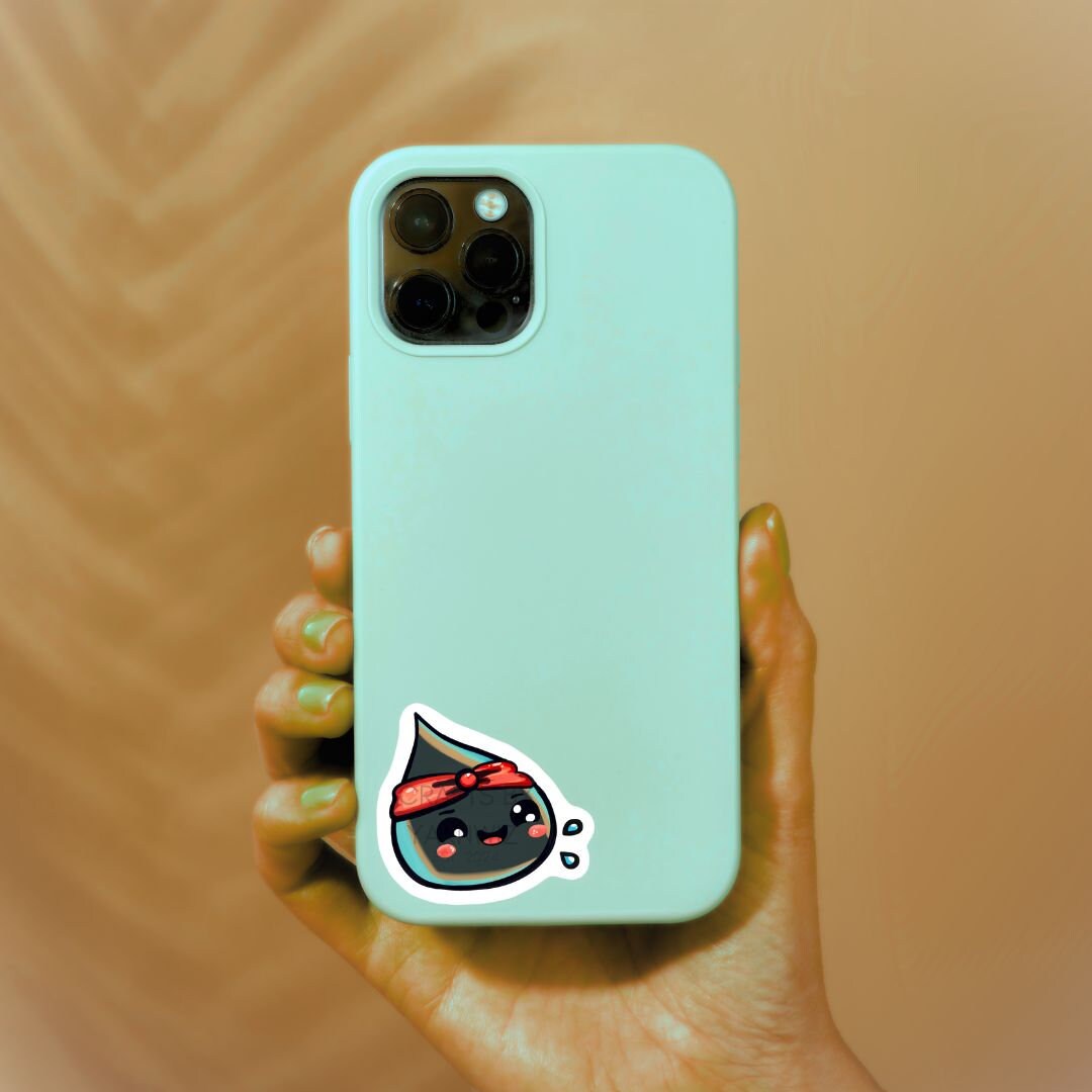 a person holding a phone with a sticker on it