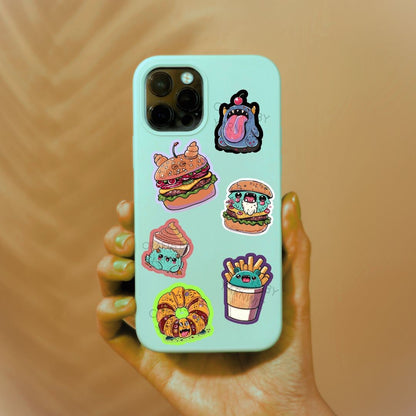 a person holding a phone case with stickers on it