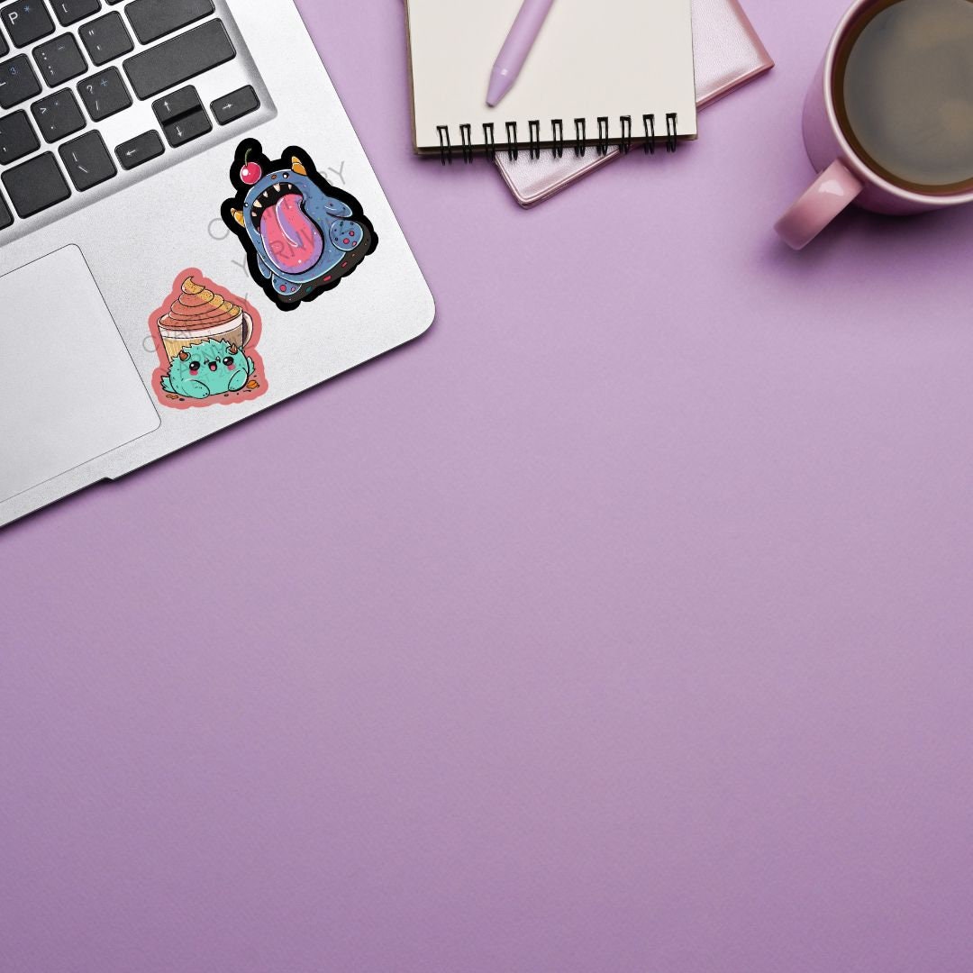 a laptop computer sitting on top of a desk next to a cup of coffee