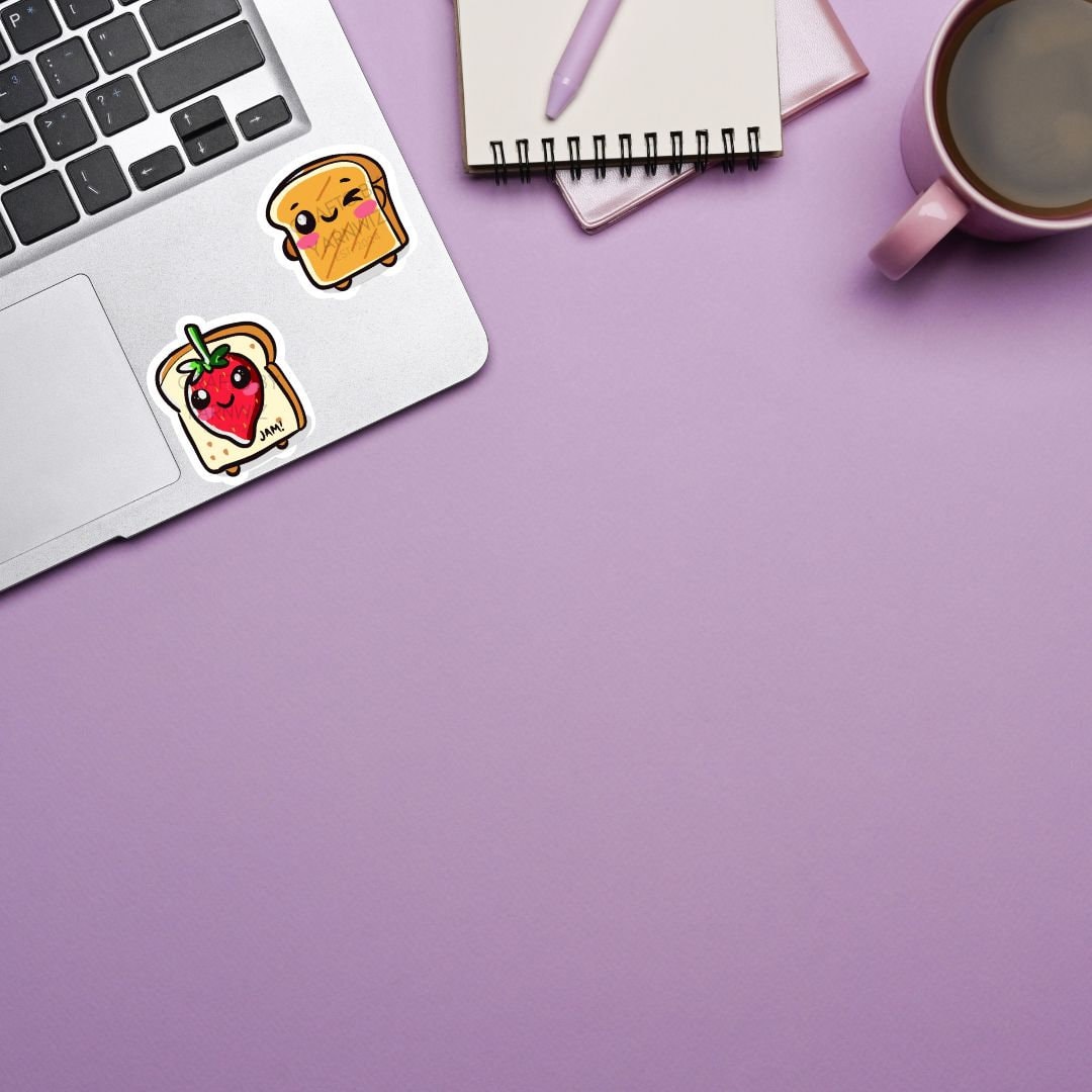 a laptop computer sitting on top of a desk next to a cup of coffee