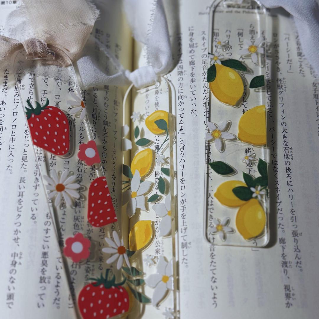 two bookmarks with strawberries and lemons on them