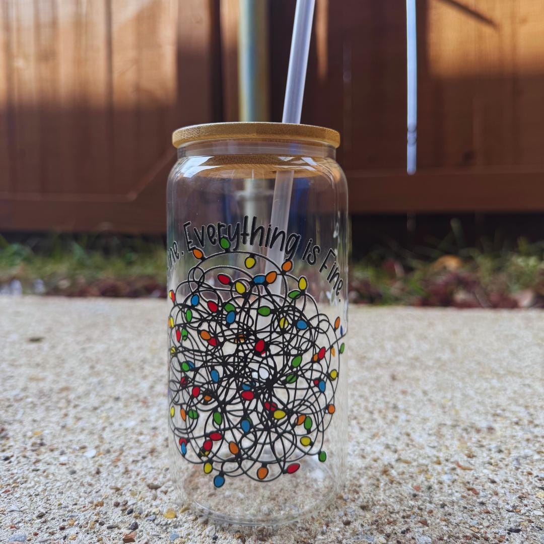 a glass with a straw in it sitting on the ground