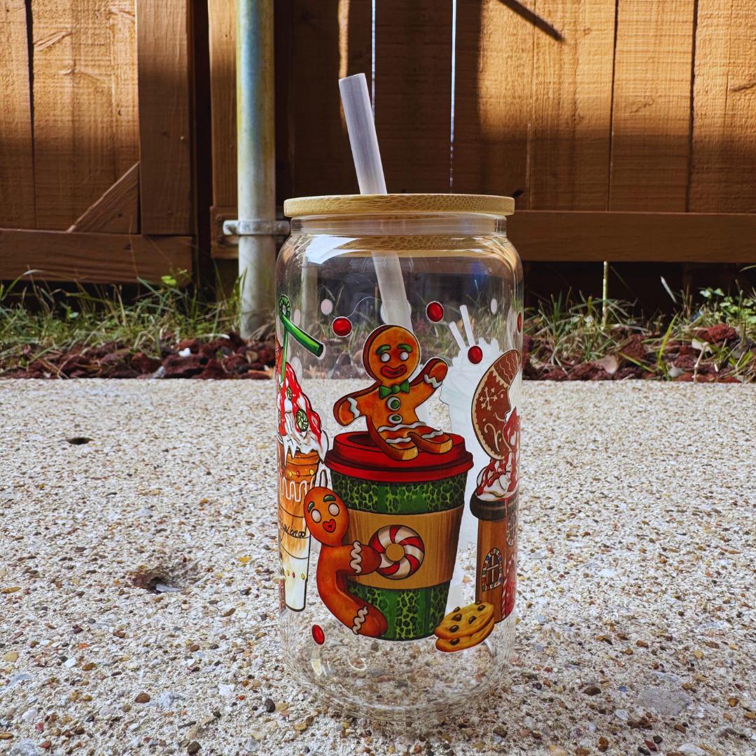 a glass jar with a straw in it sitting on the ground