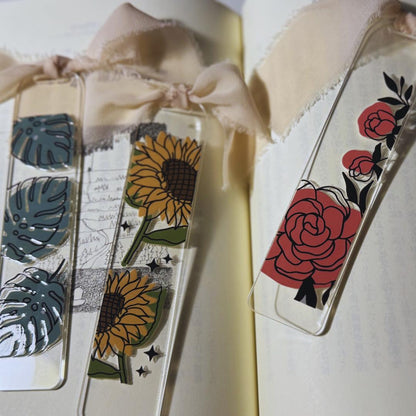 two bookmarks with flowers and leaves on them