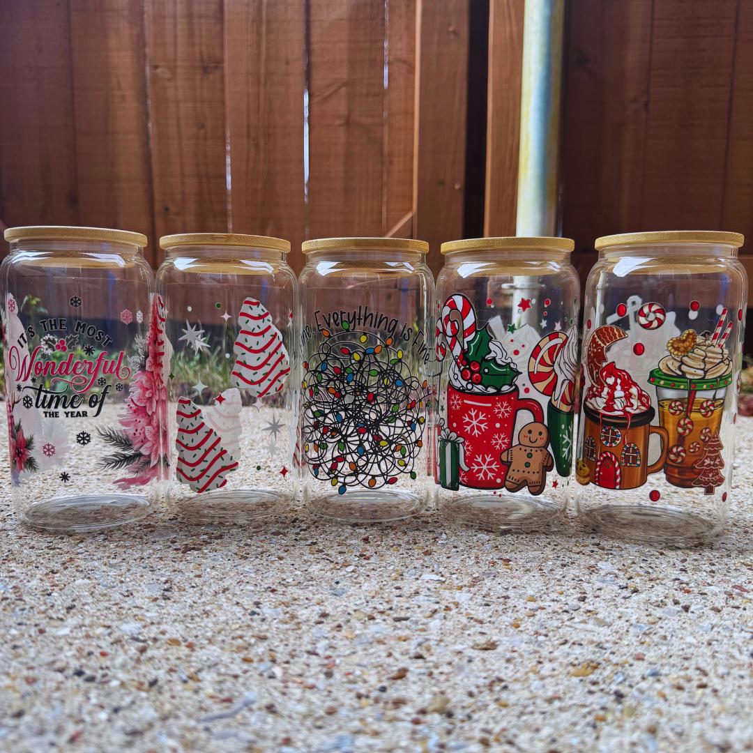 a row of glass jars filled with christmas decorations